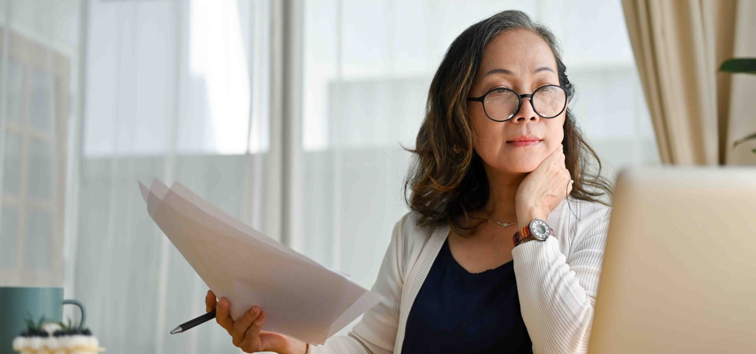 Older homeowner reading online, illustrating the Douglas County Assessor's warning about a fake federal property tax form